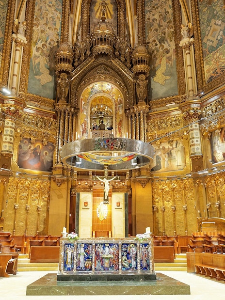 Santa Maria de Montserrat Abbey interior with ornate altar, Barcelona, Spain.
