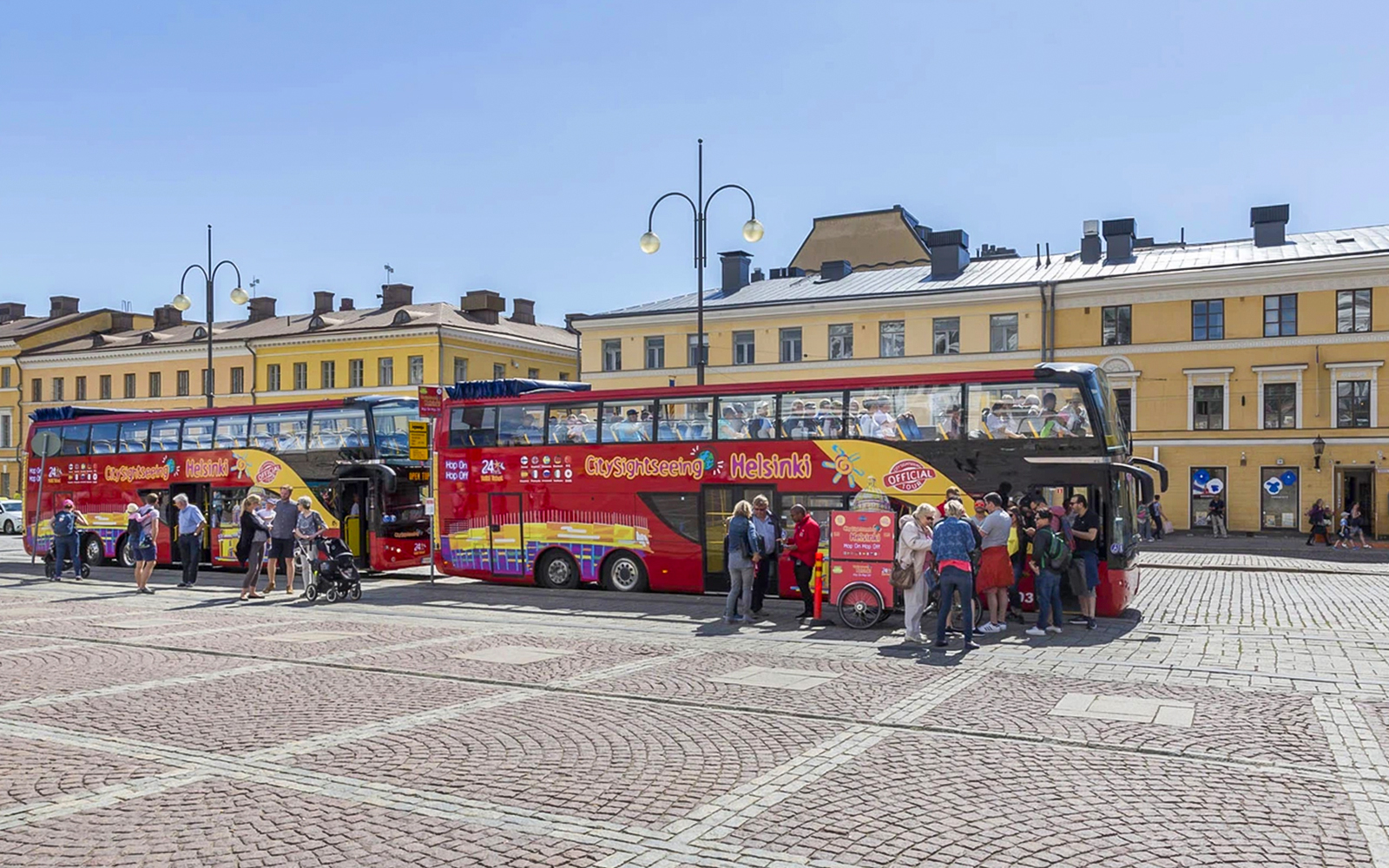 Guests boarding a red double-decker bus during Helsinki Hop-on Hop-off Bus Tour.