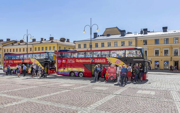 Guests boarding a red double-decker bus during Helsinki Hop-on Hop-off Bus Tour.