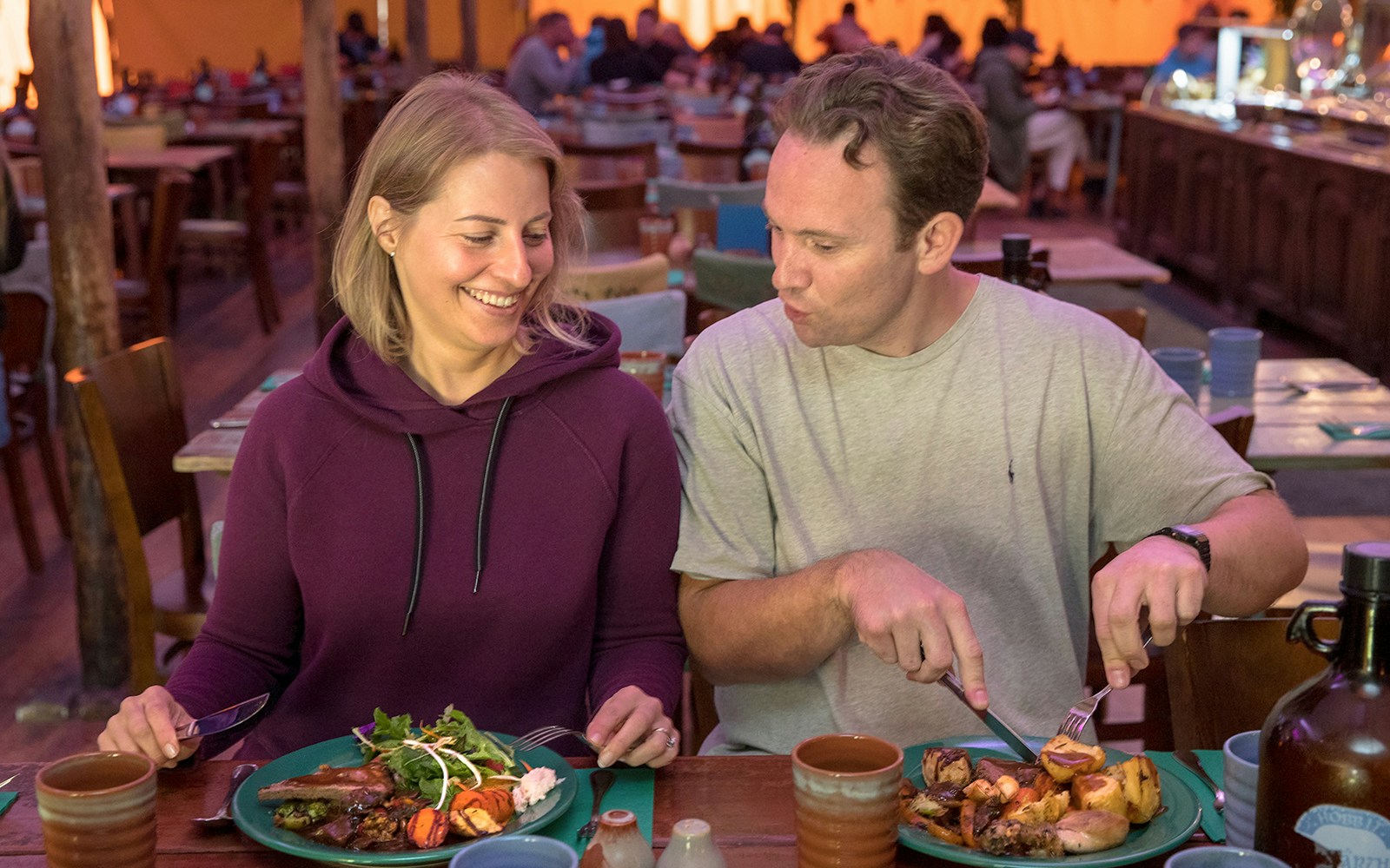 Couple dining at Hobbiton Movie Set during Auckland tour.