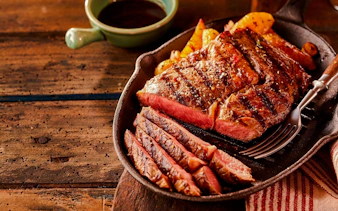 Grilled steak slices on a plate at a Brazilian steakhouse in Rio de Janeiro.