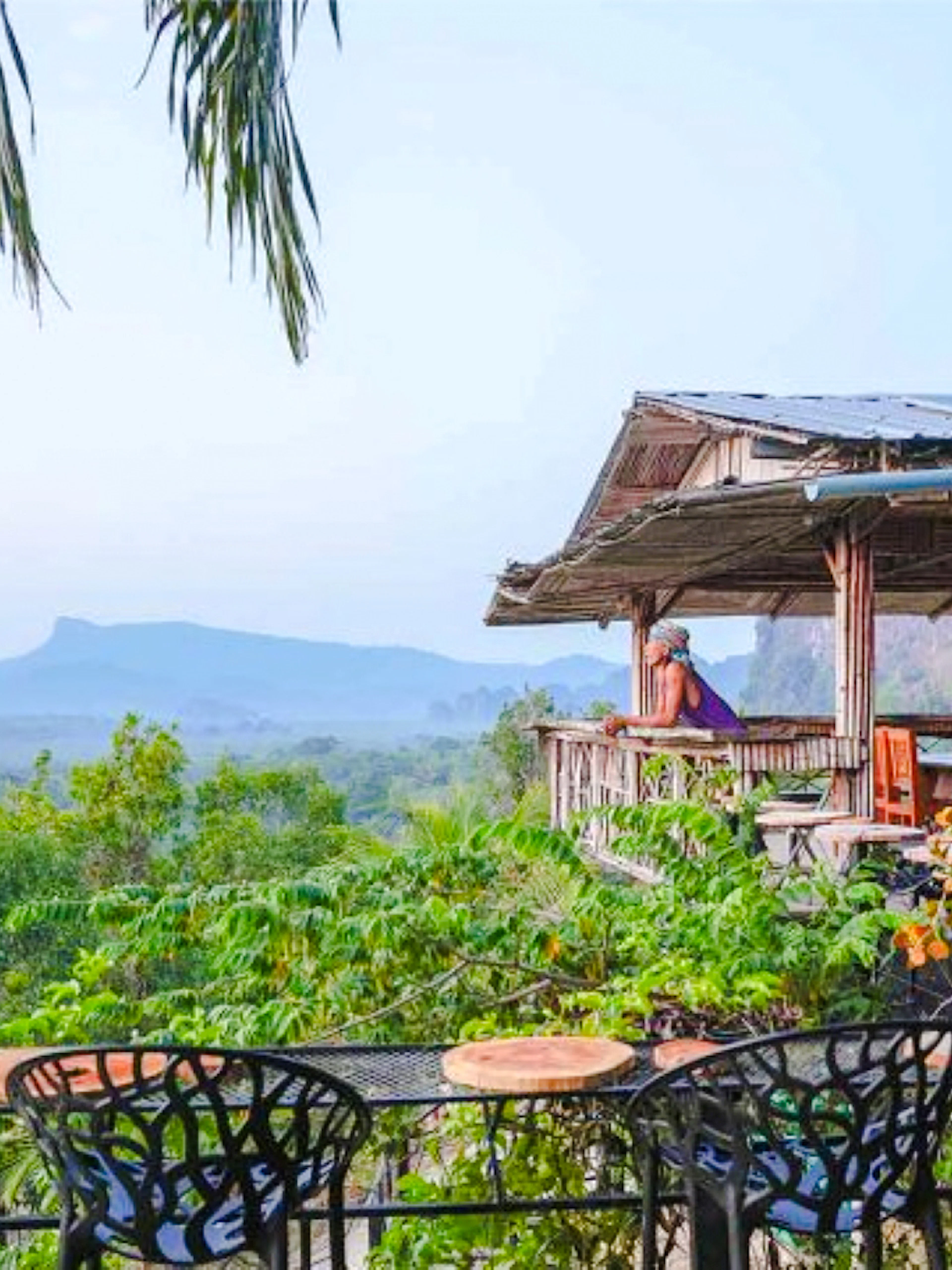 Hilltop view from Khuan Nom Sao viewpoint with lush greenery and distant mountains, Krabi.