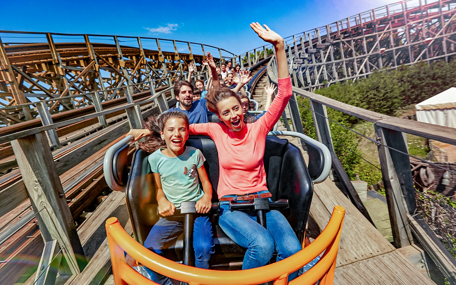 Stampida wooden roller coaster at PortAventura Park, Spain, with blue sky backdrop.