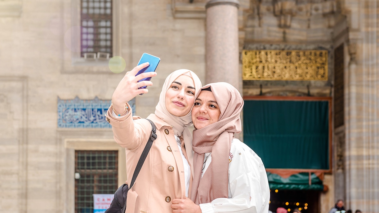 Two women taking a selfie at Sultan Suleymaniye Mosque, Istanbul.