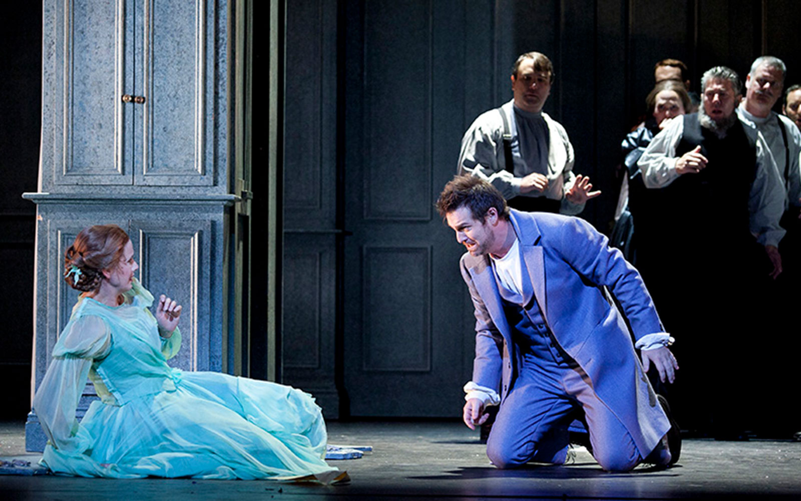 Actors performing a dramatic scene in Eugene Onegin on stage.