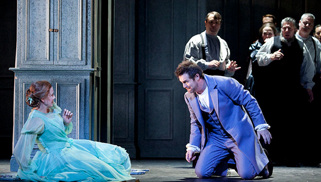 Actors performing a dramatic scene in Eugene Onegin on stage.
