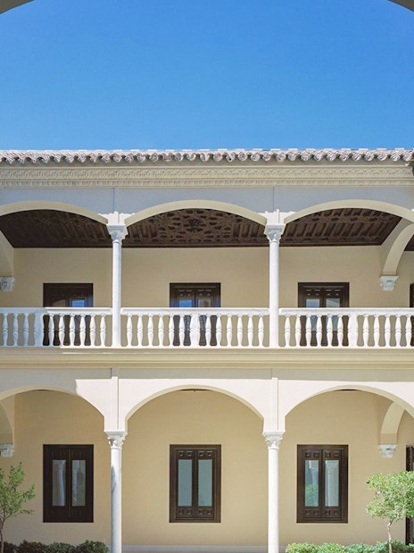 Courtyard of the Picasso Museum in Malaga with arches and columns.