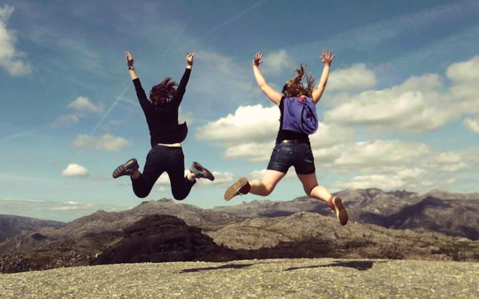 Two people jumping with joy at Peneda Gerês National Park, Portugal.