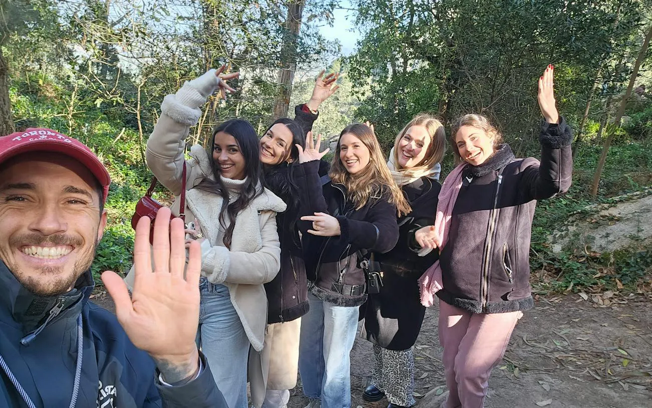 Group enjoying Sintra walking tour in forest setting.