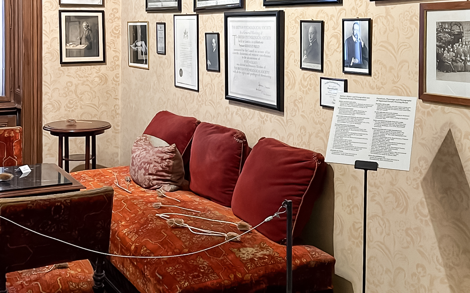 Sigmund Freud Museum interior with red couch and framed photos on the wall.