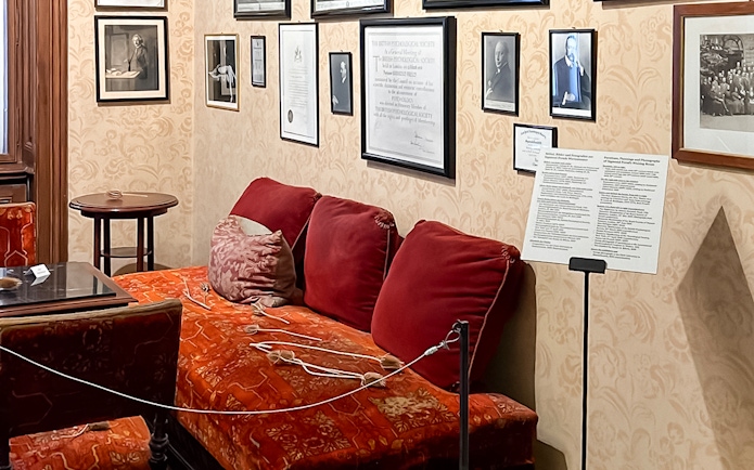 Sigmund Freud Museum interior with red couch and framed photos on the wall.