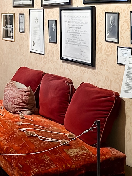 Sigmund Freud Museum interior with red couch and framed photos on the wall.