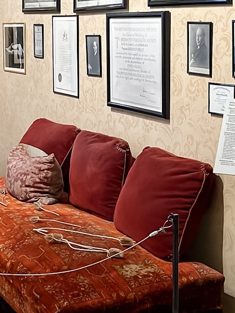 Sigmund Freud Museum interior with red couch and framed photos on the wall.