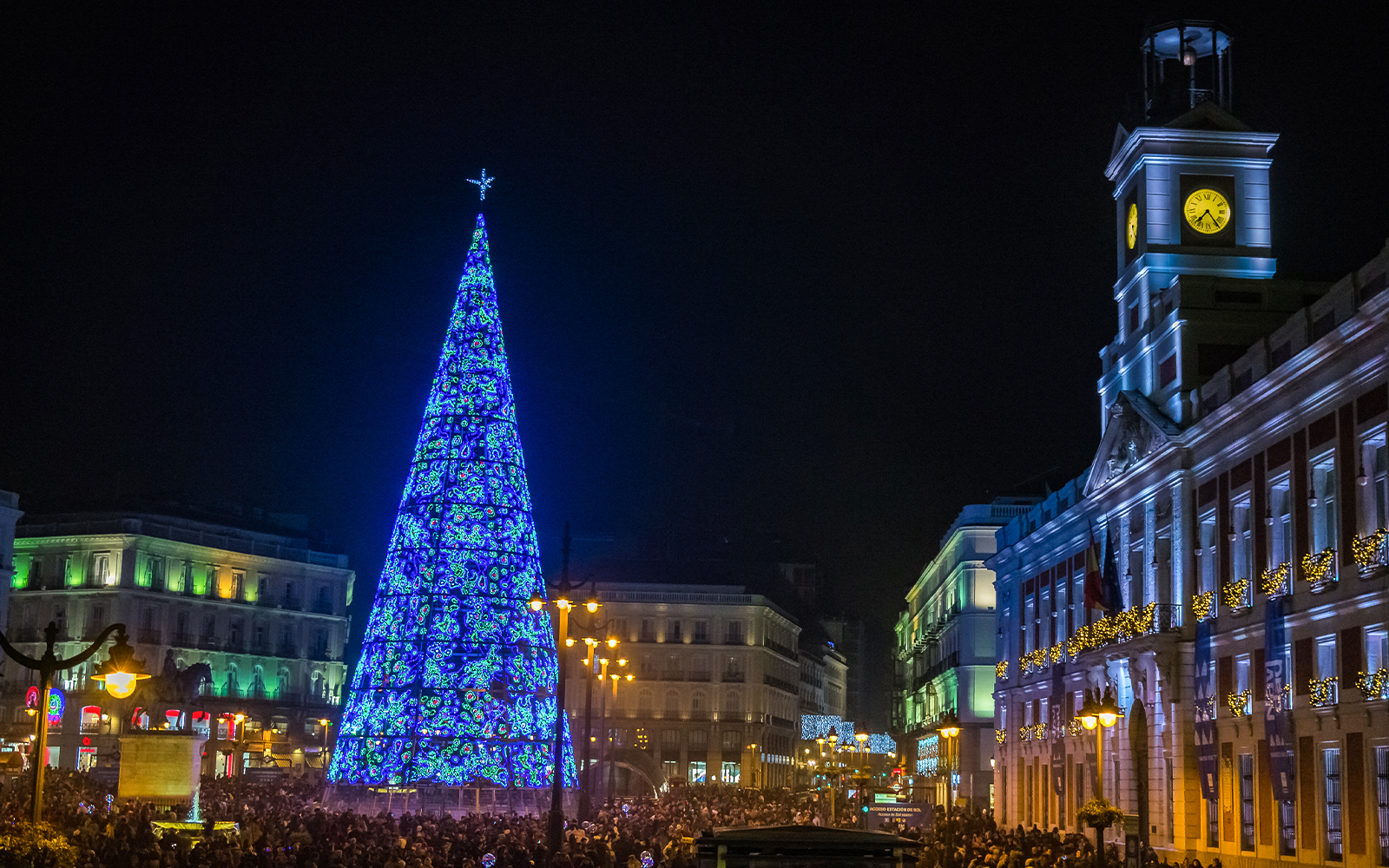 Puerta del Sol Clock Tower and illuminated Christmas tree at night, Madrid, Spain.