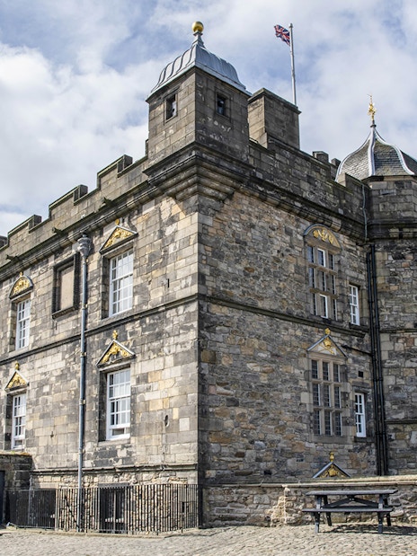 Edinburgh Castle stone facade with archway on guided walking tour.