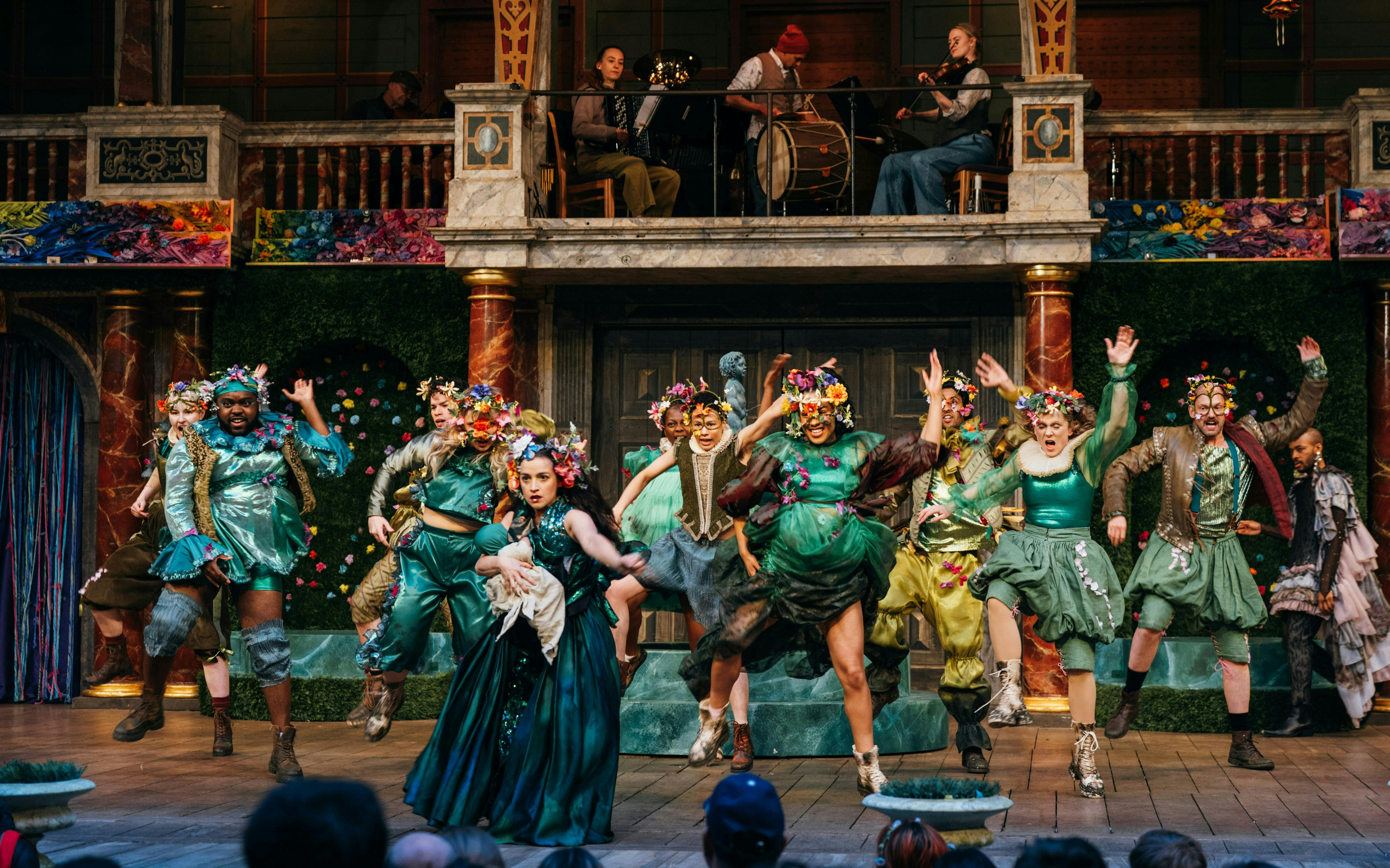 Stage performance of A Midsummer Night’s Dream in West End with actors in colorful costumes.