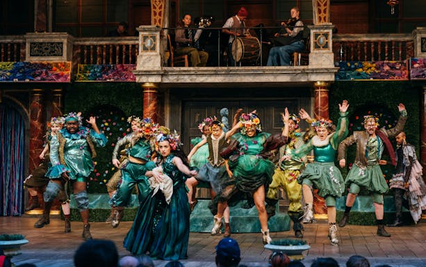 Stage performance of A Midsummer Night’s Dream in West End with actors in colorful costumes.