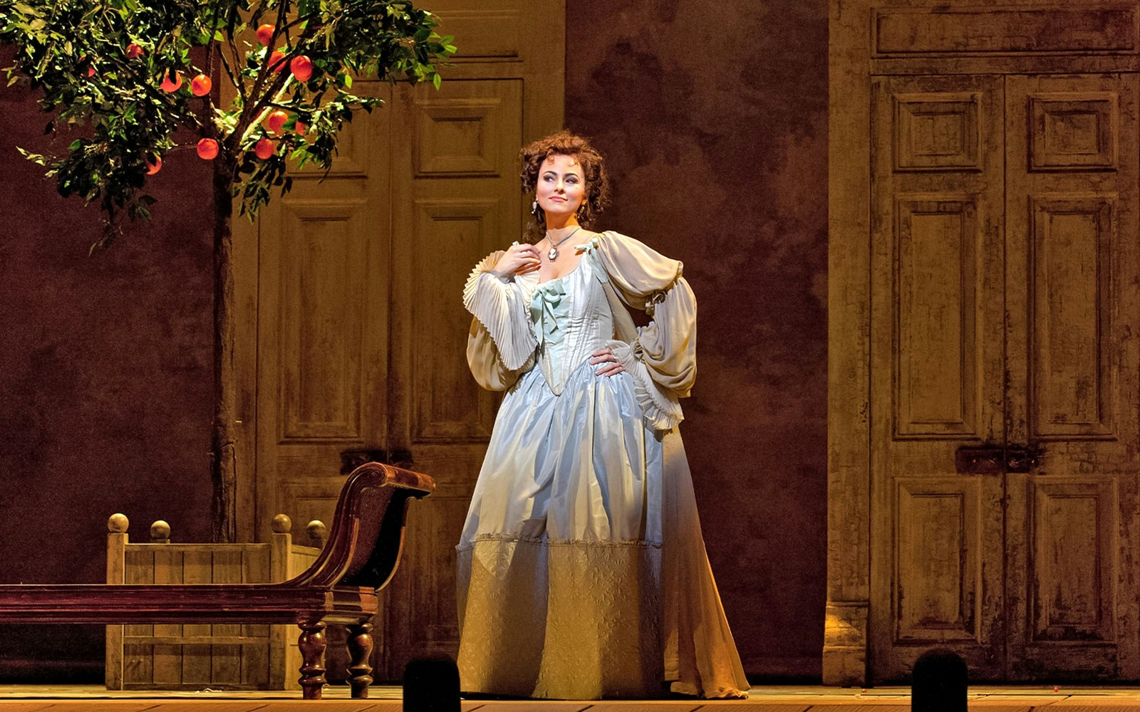 Opera performer in period costume on stage for Il Barbiere Di Siviglia.