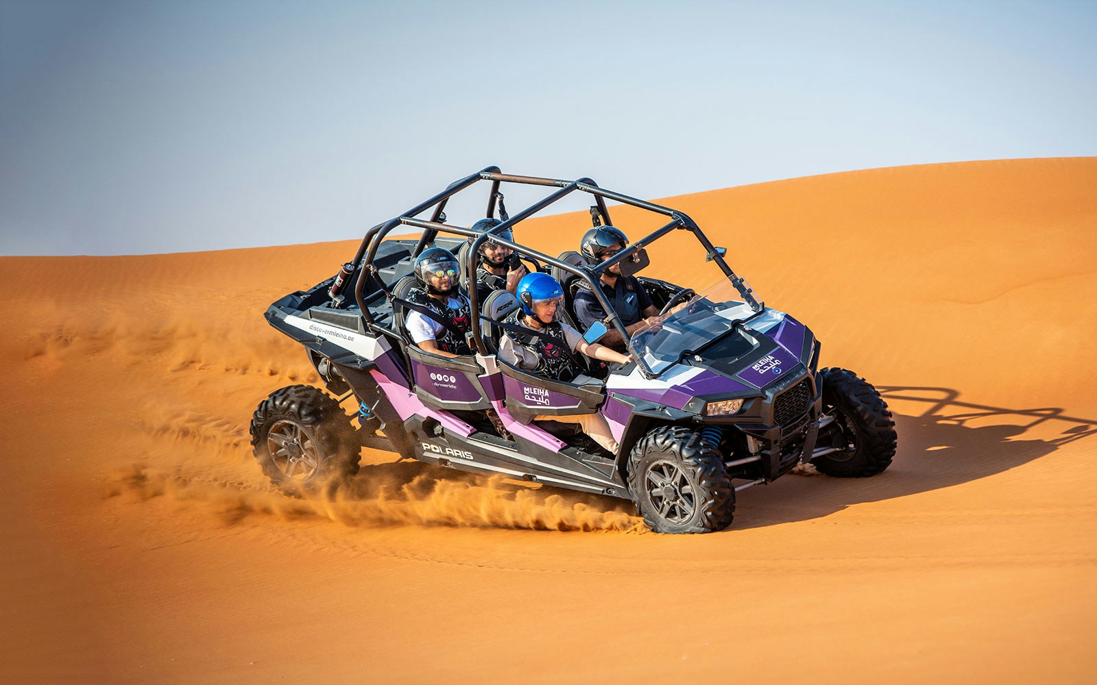 Dune buggy driving through sand dunes on a self-drive tour in Mleiha.