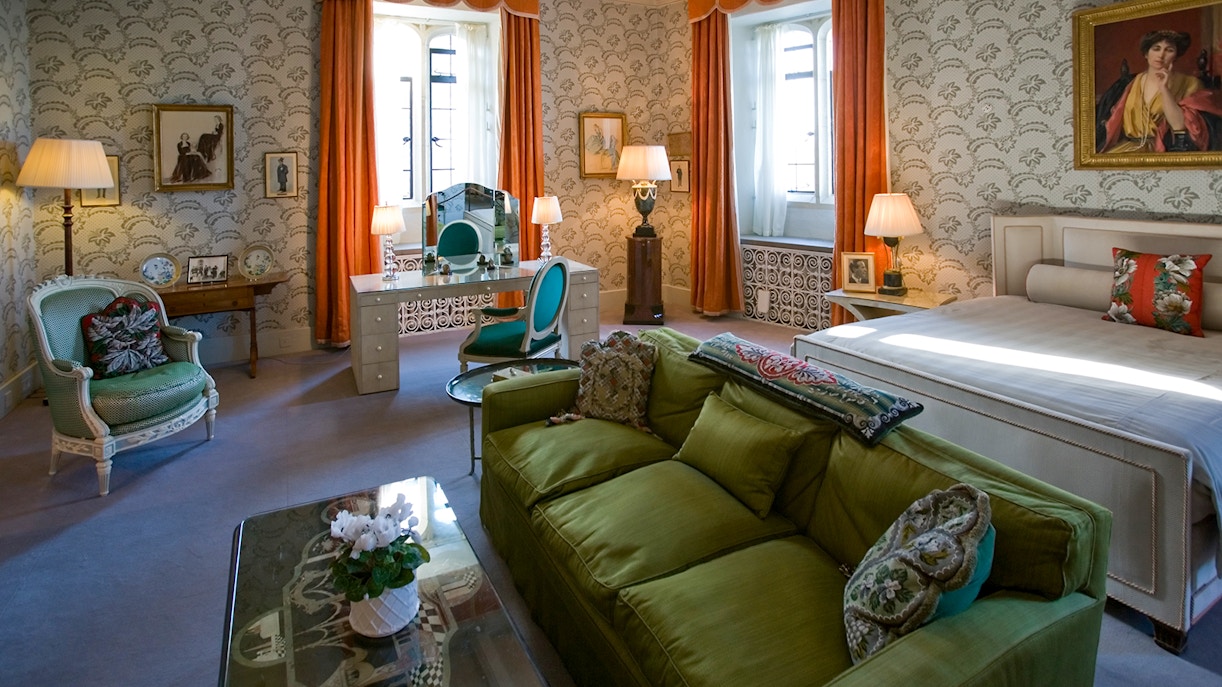 Leeds Castle bedroom with vintage decor, green sofa, and ornate dressing table.