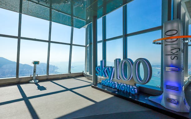 Sky100 observation deck with panoramic view of Hong Kong skyline and harbor.