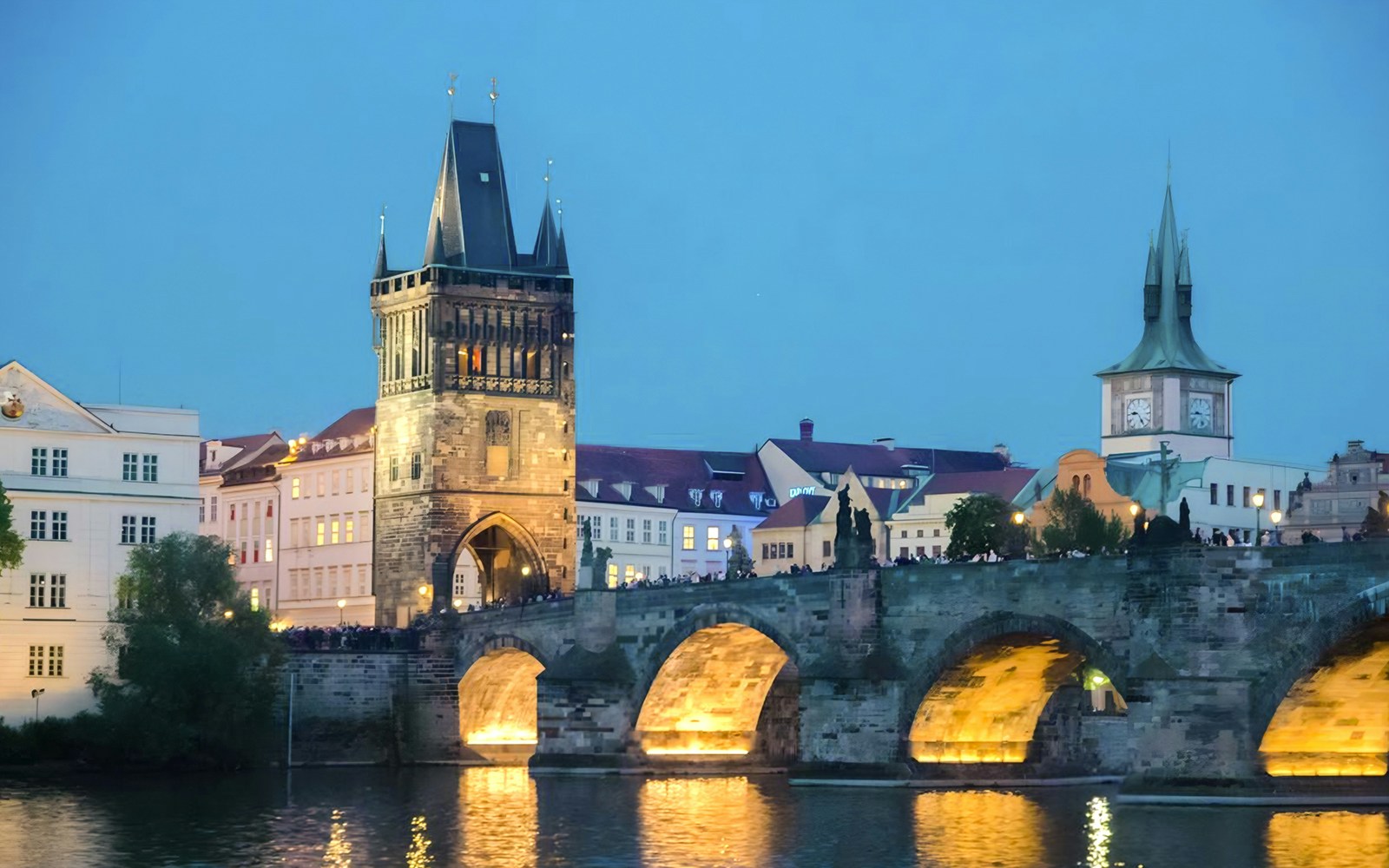 View of Charles bridge in the evening on Prague Dinner Cruise