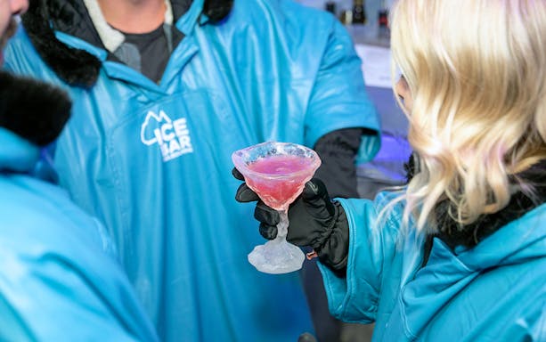 Guests at IceBar Melbourne holding drink in ice glass.