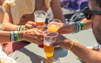 Cheers with drinks on a Formentera cruise tour boat.
