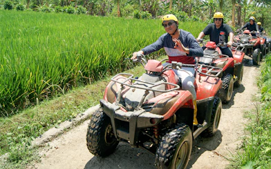 ATV riders on a guided tour through Bali rice fields.