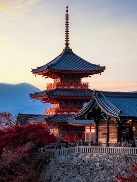 Pagoda at Kiyomizu-dera Temple in Kyoto, Japan, during sunset with autumn foliage.