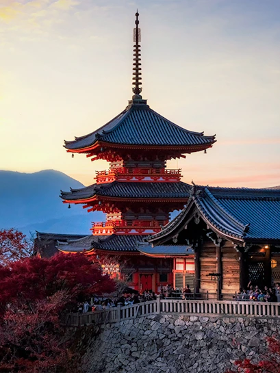 Pagoda at Kiyomizu-dera Temple in Kyoto, Japan, during sunset with autumn foliage.