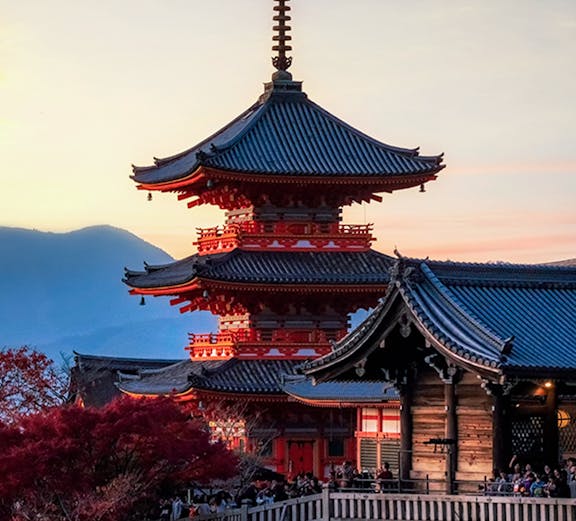 Pagoda at Kiyomizu-dera Temple in Kyoto, Japan, during sunset with autumn foliage.