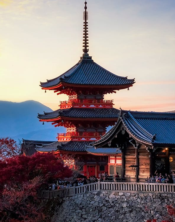 Pagoda at Kiyomizu-dera Temple in Kyoto, Japan, during sunset with autumn foliage.
