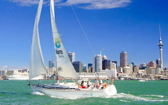 Sailing cruise on Waitematā Harbour with Auckland skyline in the background.
