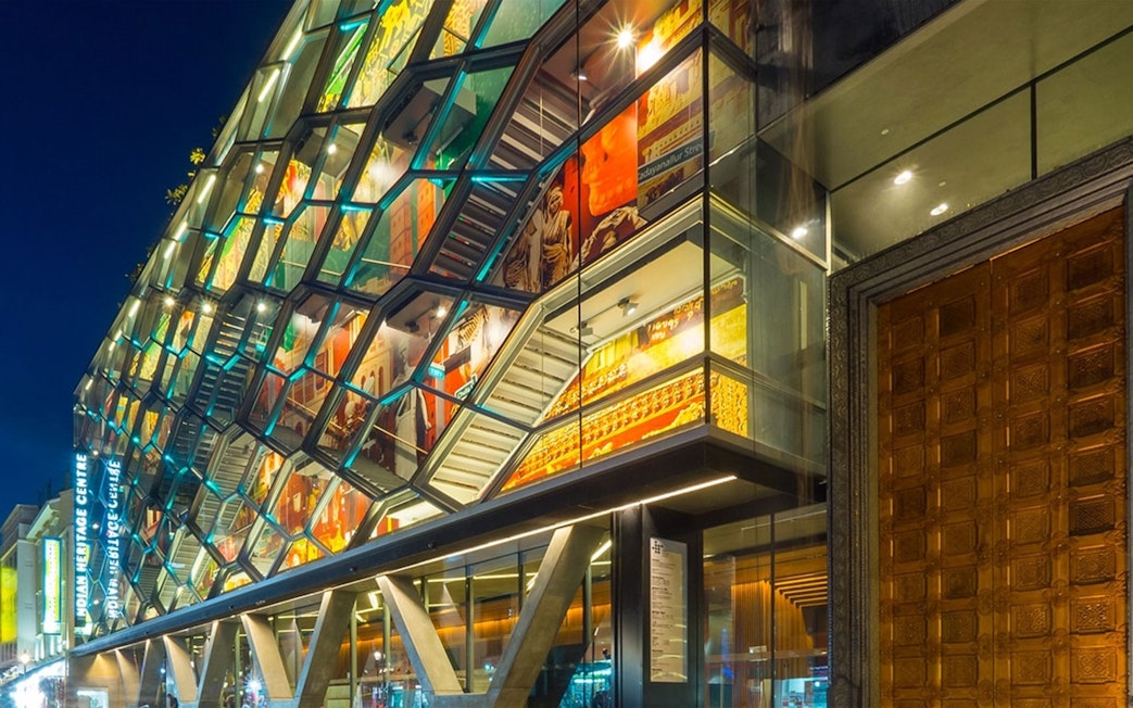 Indian Heritage Centre facade at night with colorful projections, Singapore.
