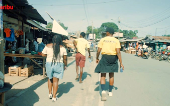 Tourists walking through a local market during a village bike tour in Diani Beach.