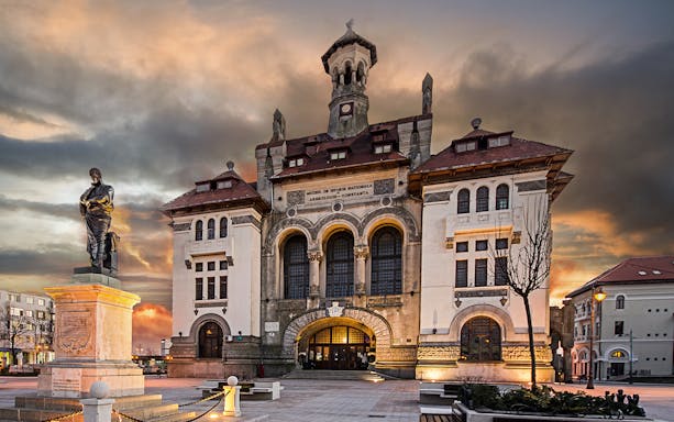 Constanta National History Museum with statue at sunset during guided walking tour.