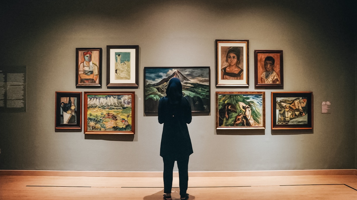 Visitor admiring paintings at Van Gogh Museum Amsterdam.