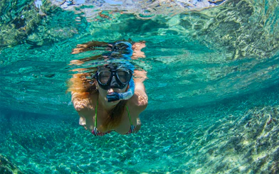 Snorkeler exploring clear waters near Tavolara Island.