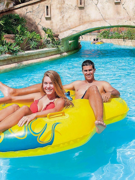 Couple enjoying a lazy river ride at Aqualand Maspalomas.