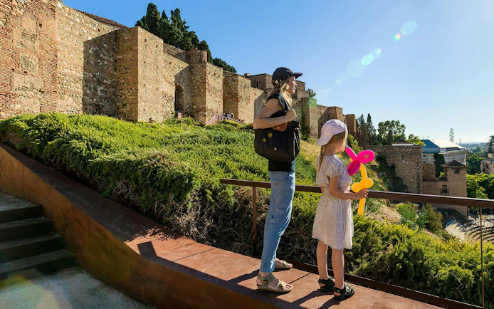Tourists overlooking Gibralfaro Castle in Málaga, Spain.