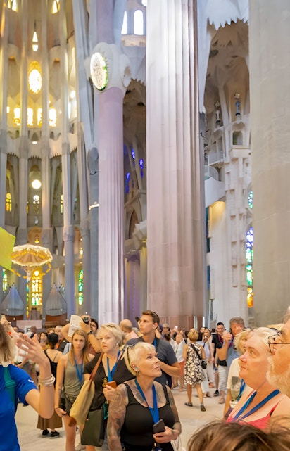 Guide leading tourists inside Sagrada Familia, Barcelona.
