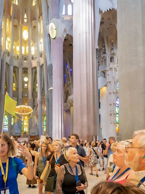 Guide leading tourists inside Sagrada Familia, Barcelona.