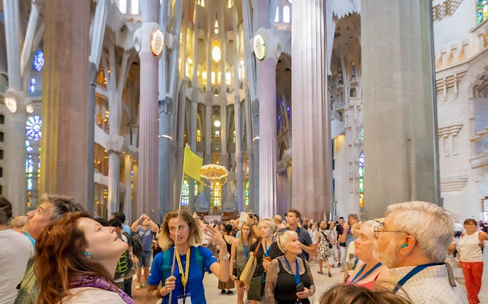 Guide leading tourists inside Sagrada Familia, Barcelona.