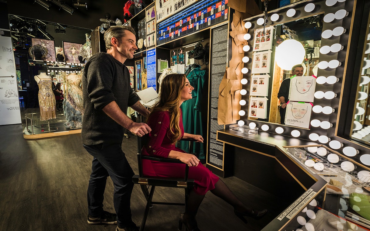 Visitors exploring costume displays at The Museum of Broadway.