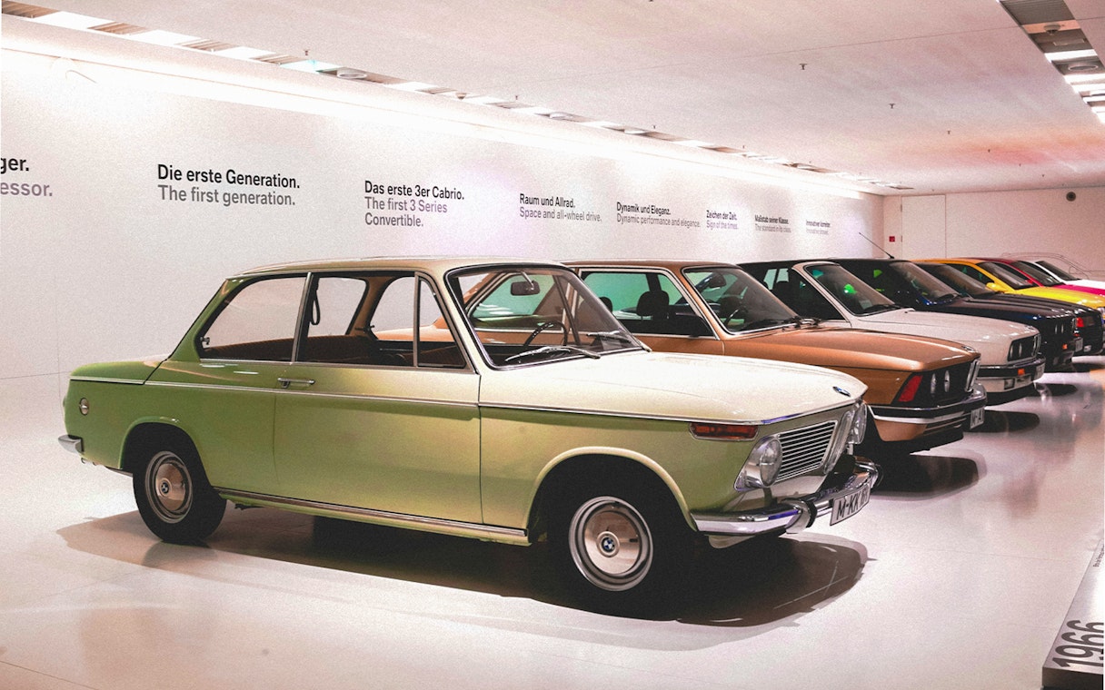 Vintage cars displayed at a museum exhibit in Munich, Germany.
