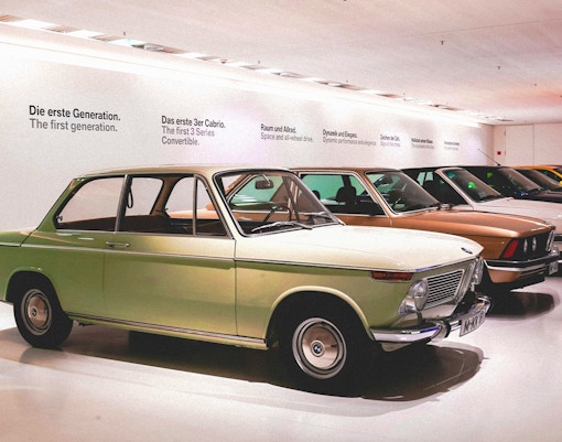 BMW Museum Stuttgart exhibit with classic and modern BMW cars on display.