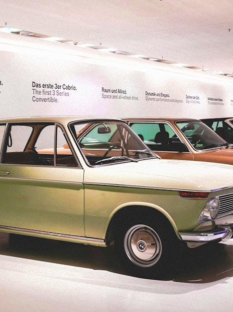 Vintage cars displayed at a museum exhibit in Munich, Germany.