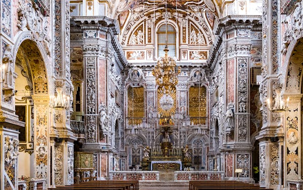 Palermo cathedral interior with ornate baroque architecture and detailed frescoes.