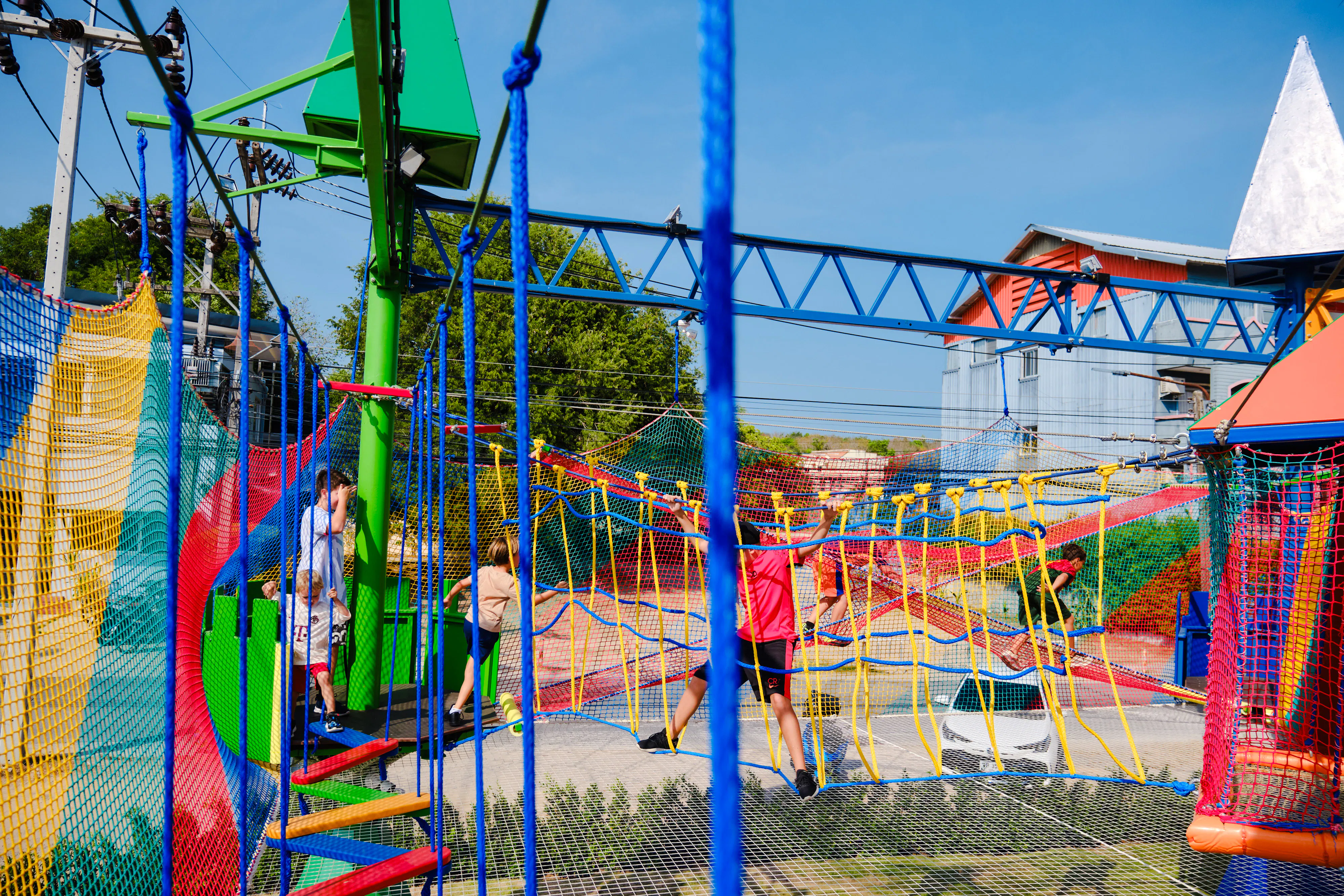 Children playing on colorful climbing nets at a birthday party venue in Phuket.